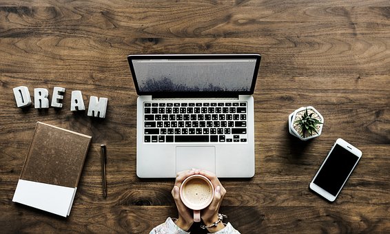 computer with coffee and dream caption